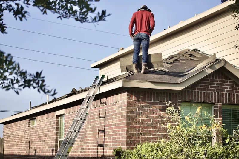 Professional roofer working on a residential roof in Redbird
